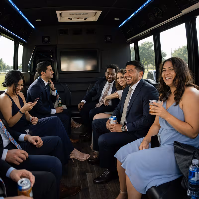 Wedding guests seated inside a Arlington party bus