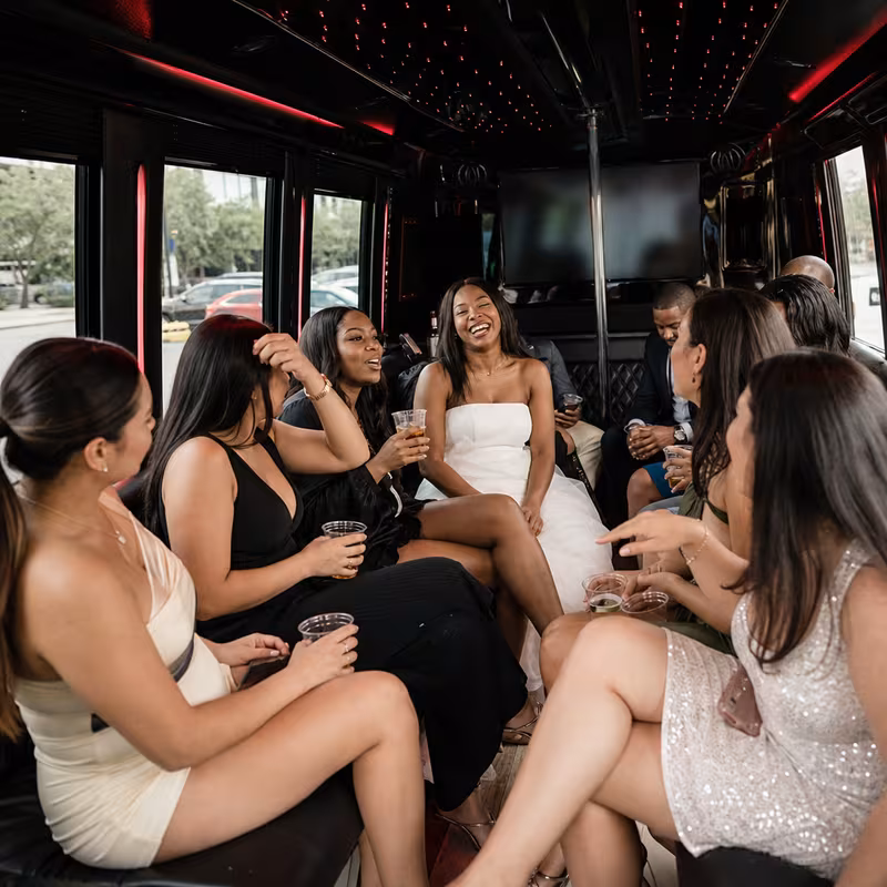 Party bus interior with wraparound leather seating and LED lighting in Arlington