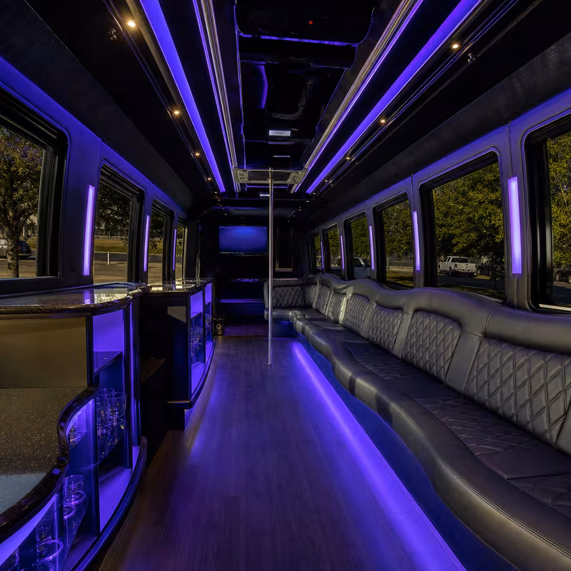 Party bus interior with wraparound leather seating and LED lighting in Arlington