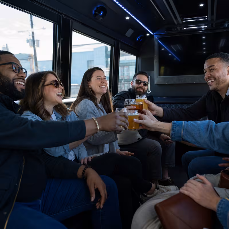 Group boarding a white charter bus for Winery & Brewery Tour Transportation transportation in Arlington