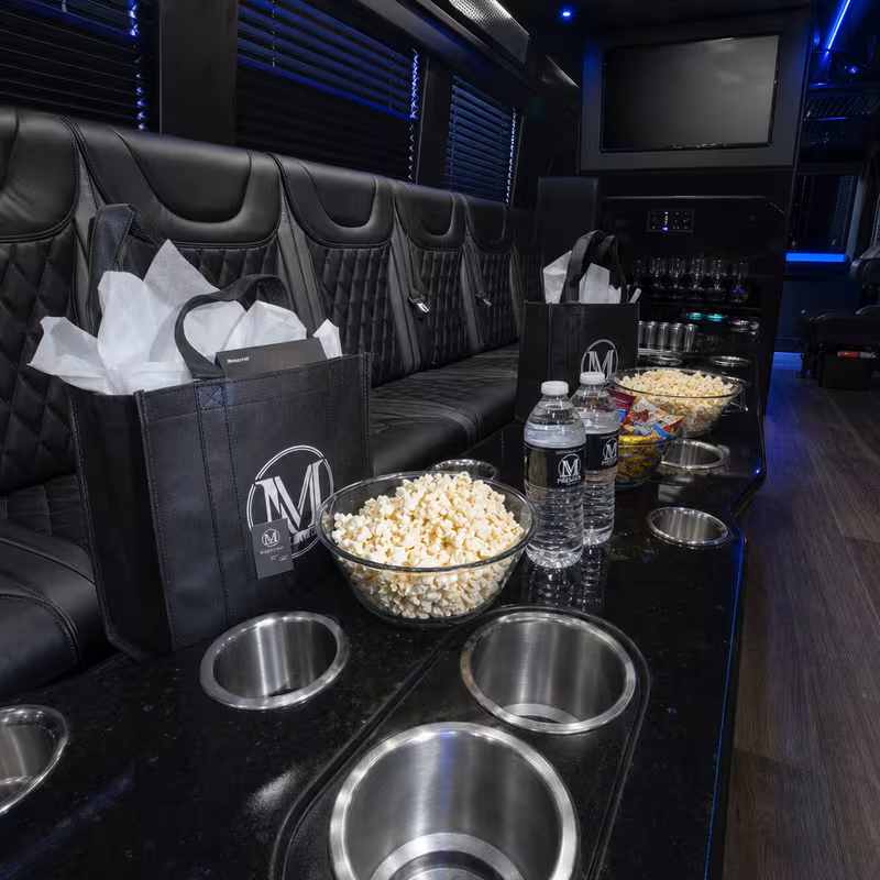 Party bus interior with wraparound leather seating and LED lighting in Arlington